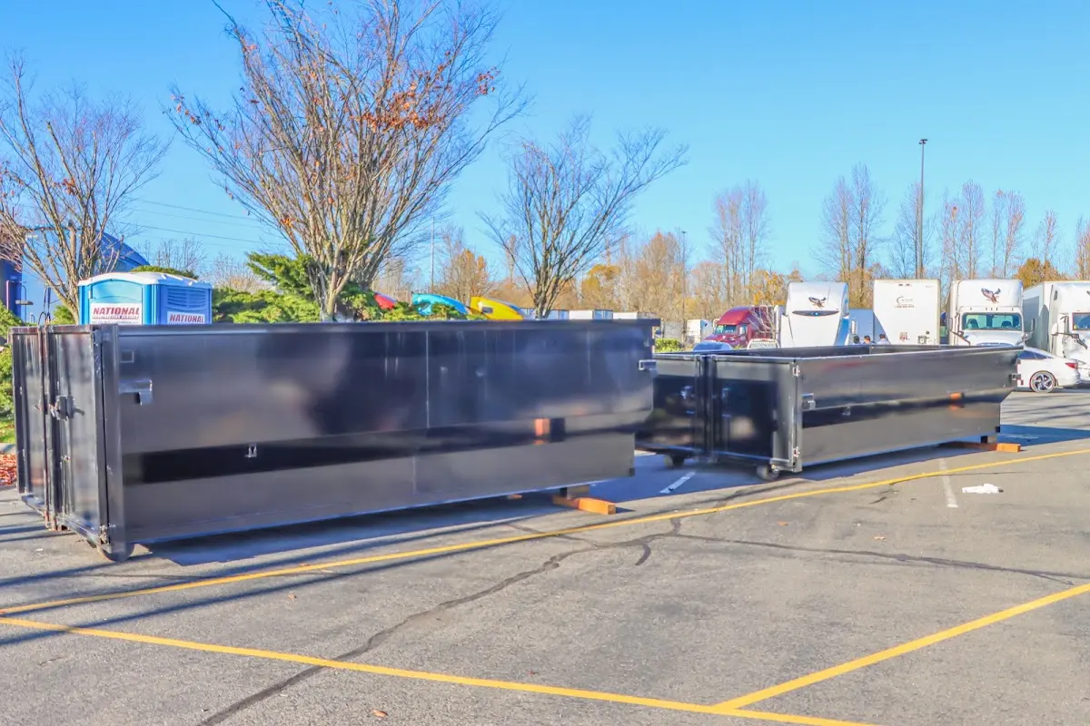 Professional dumpster rental service with roll-off container on residential driveway in Highland Lakes